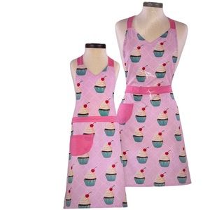 Brand new in original packaging never opened matching adult and child aprons